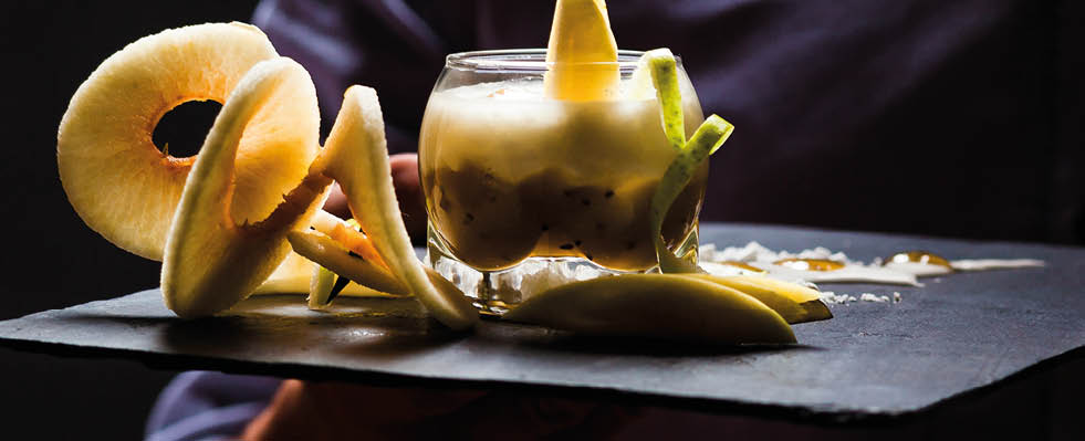 Waiter presents a dessert with cheese and apples