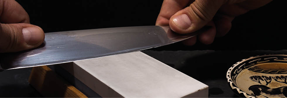 sharpening the knife with whetstone