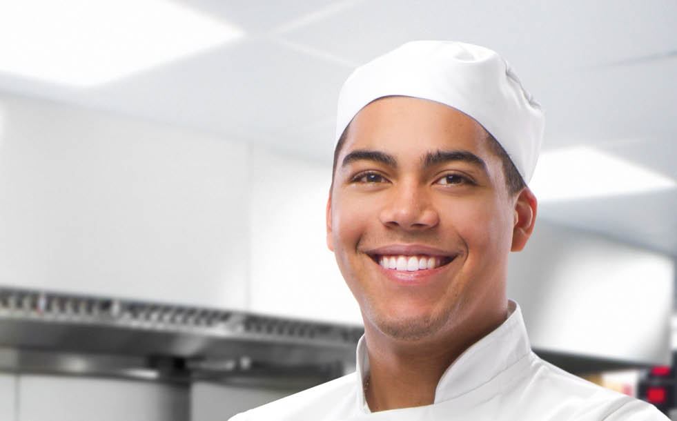 happy trainee chef in modern kitchen