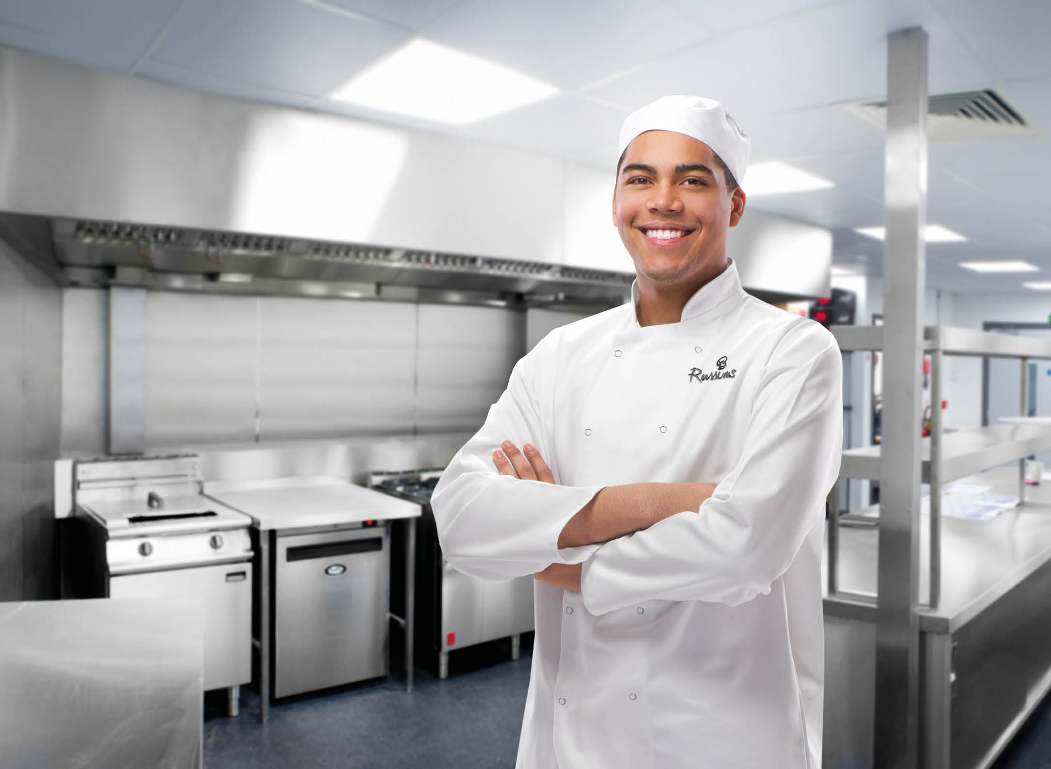 happy trainee chef in modern kitchen