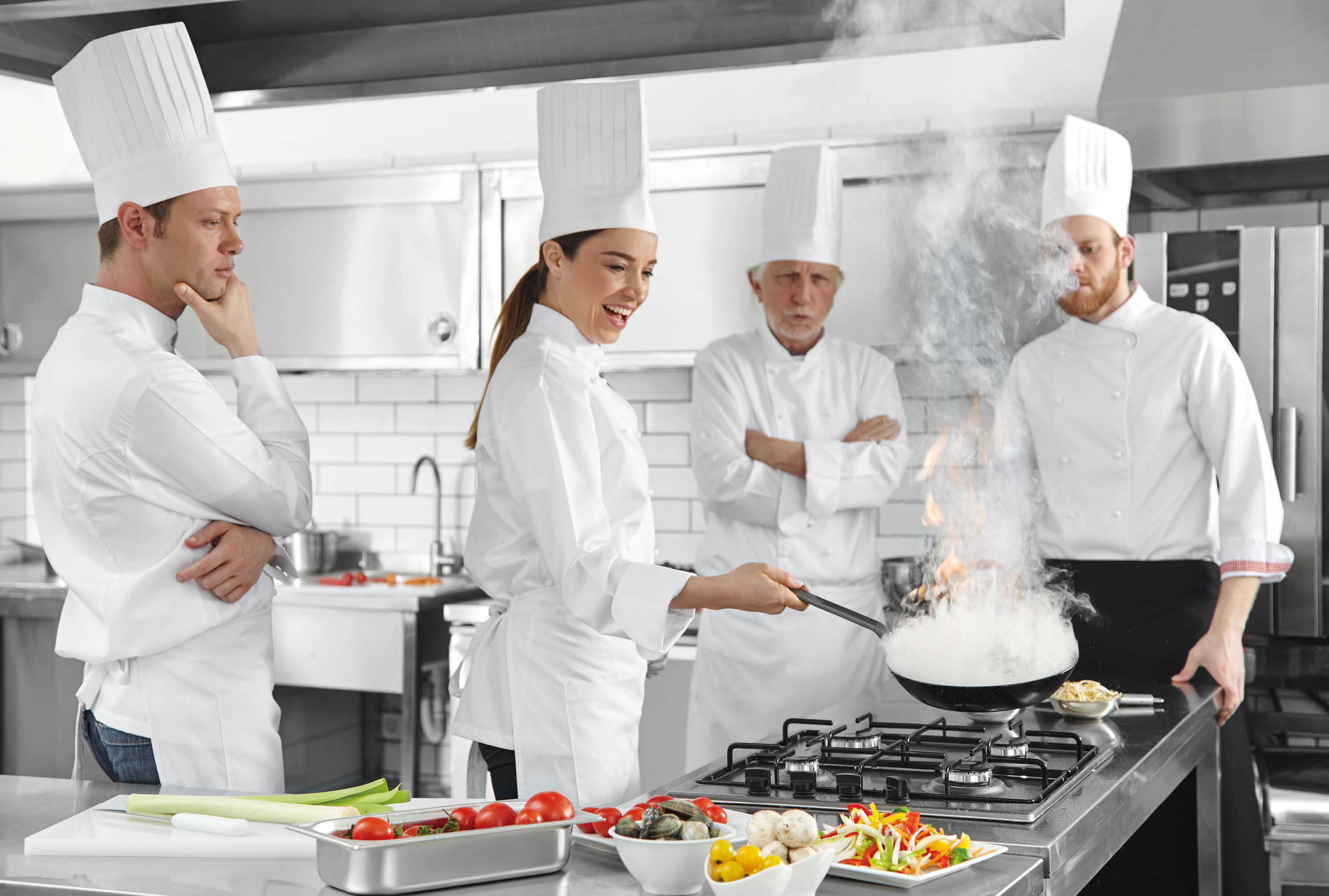 Chef cooking oyster in flaming pan