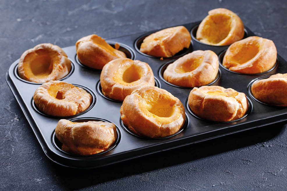 close-up of traditional Yorkshire puddings in a baking tray on a concrete table, english cuisine, view from above