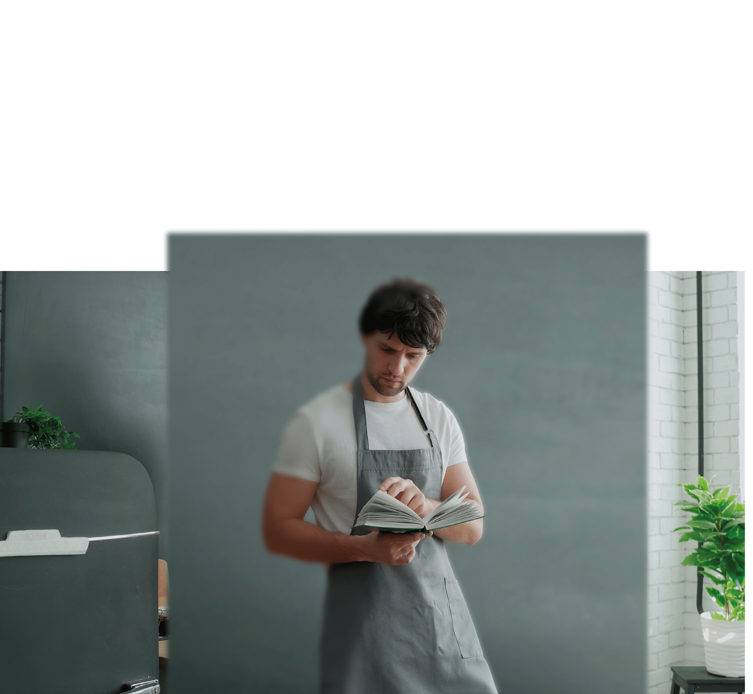 Man cooking in kitchen reading recipe from cookery book.