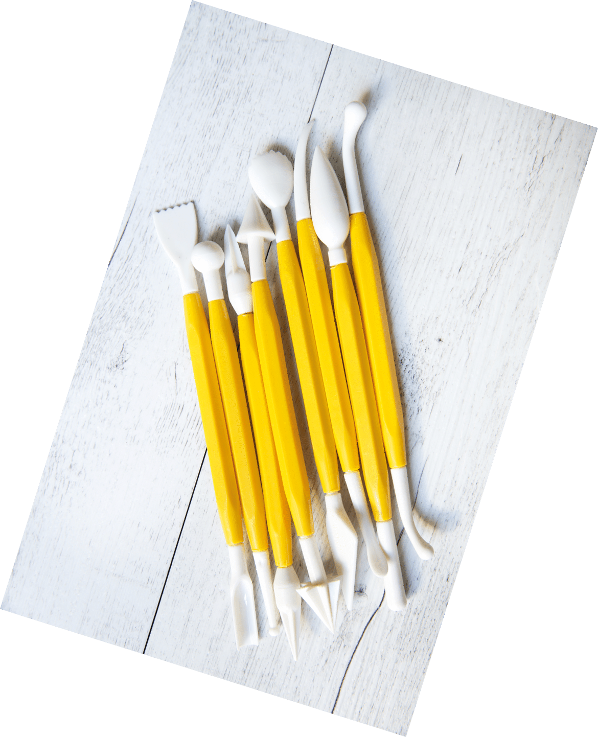 Tool for modeling sugar paste on a wooden background